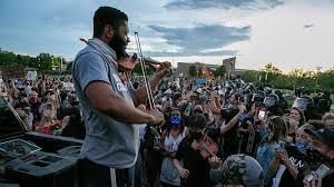 Elijah mcclain died in august 2019, after police in aurora colorado confronted him as he walked home from a convenience store. Violin Vigil For Elijah Mcclain Interrupted By Riot Police