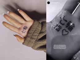 A Complete Guide To Ariana Grande S 55 Known Tattoos 108 wording tattoo on hand. ariana grande s 55 known tattoos