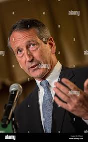 Former South Carolina Gov. Mark Sanford, right, speaks with voter Travis  Holt, a mechanic with the U.S. Air Force, at Orlando's Pizza in Daniel  Island, S.C.,