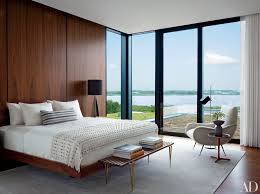 Seating arrangement under the long window and bed placed in the center of two windows of the rustic style bedroom is an amalgamation of rustic with modern setting. 24 Contemporary Bedrooms With Sleek And Serene Style Architectural Digest