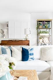 A coastal living room with a white ektorp sofa, a rattan coffee table, blue stools and coastal artworks. Review Of The Ikea Farlov Sofa Line Two Years In The Happy Housie