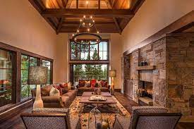 Alpine Living Room With Large Stone Fireplace Wood Flooring And High Ceiling Rustic Living Room Beautiful Living Rooms Family Room Design