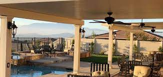 Menifee california patio cover, bbq island with poured in place colored counter top, raised fire pit area with seat wall, synthetic grass and lighting. Aluminum Patio Covers Menifee Alumawood