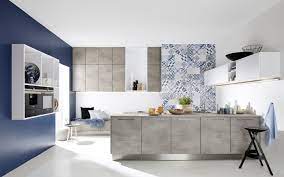 The white corian units below were complemented beautifully with aged blue limestone tiles which feature subtle ageing to the edge to create a soft, rustic tile. Kitchen Island And Wall Units With Concrete Look Nolte Kuechen Com