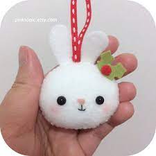 From the proud lift of her chin to the strands of hair caught by the wind, she appears to weather all storms. Christmas Bunny Winter Bunny Felt Christmas Ornament Felt Christmas Ornaments Felt Christmas Christmas Ornaments