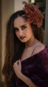 “Bold and dramatic makeup featuring deep purple lipstick, smoky eyes, and a  flawless base, complemented by a soft blush and feather hair accessory for  a striking, elegant look.” Makeup by me ...