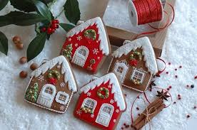 Close up of woman making gingerbread houses. Christmas House Cookies Gingerbread House Cookies Christmas Cookies Christmas Cookie Recipes Holiday