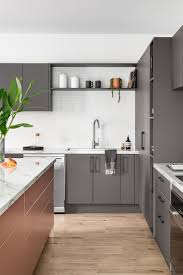 #light grey ( looks white really)stunning transitional kitchen features a stainless steel range sat against white herringbone backsplash tiles holding a light gray paneled hood flanked by light gray shaker cabinets fitted with polished nickel pulls and framed by ivory shiplap walls. Colourful Kitchen Cabinetry Ideas 6 New Trends For The Home