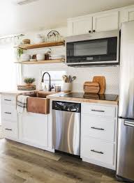 A properly designed small kitchen has minimal clutter and maximum efficiency. Rv Kitchen Remodel With White Cabinets And Wood Look Flooring Rv Kitchen Remodel Small Kitchen Decor Kitchen Remodel Small