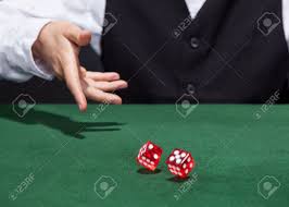 Croupier Throwing A Pair Of Red Dice Across The Green Felt On ...