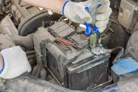 Be sure there are no foreign objects lying in the tray that may cause damage to the bottom of the battery container. Man Hands Using Pliers Remove Car Battery Terminals To Change Stock Photo Picture And Royalty Free Image Image 150082630