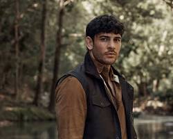 Image of man wearing the vest in a rugged outdoor setting