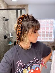 Once your hair is up in a ponytail or bun, wrap the folded bandana around it a couple of times and tie it with a knot. How To Wear Scarves For Short Hair Uptown With Elly Brown