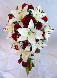 Check out this white rose bouquet with lilies and orchids and see more inspirational photos on theknot.com. Teardrop Wedding Bouquet Ivory Lillies Burgundy Roses Pearl Loops Cascading Wedding Bouquets Winter Wedding Bouquet Winter Wedding Flowers