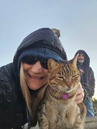 Bibi, the beautiful pier kitty, enjoys a sunrise at Kure Beach