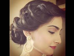 The lady is adopting a traditional occasion as per the background and the get up of the lady in this picture. 29 New Style Bun Hairstyles For Long Hair With Saree