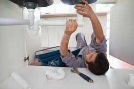 Throw away the traditional p trap to minimize leaks and maximize diy plumbing sink plumbing installation. Plumber Working On Kitchen Sink Stockphoto