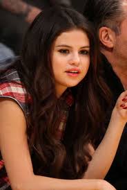 Part your hair on one side and pin up the curls on the side with lesser hair. Selena Gomez At The Laker Game With The Hair Which Is Fake Lainey Gossip Entertainment Update