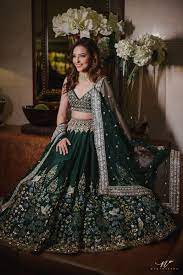 At Their Sangeet Benaisha In A Emerald Green Lehenga Embellished With Intricate Hand Painted Pichhwai Wo Indian Lehenga Indian Wedding Outfits Lehenga Designs