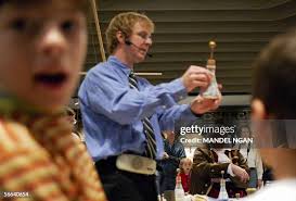 Ralph Archbold, dressed as Benjamin Franklin, blows out candles 21... News  Photo
