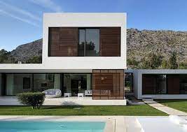 Rumah berbentuk kotak dan beratap flat itu memiliki banyak jendela. Minimalist Homes Casas Modernas Arquitectura Casas Contemporaneas Diseno Exterior