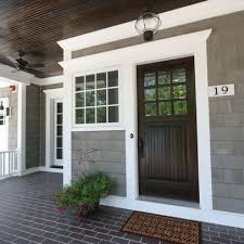 Front Door Color Ideas Check Out The Dark Stained Front Door With The Contrasting White Trimwork And Gray S House Exterior Exterior House Colors House Colors