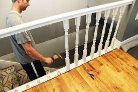 Many modern railings have a small hole underneath to access the nut holding the bolt in the newel post in place inside the railing. Diy Stair Handrail With Industrial Pipes And Wood