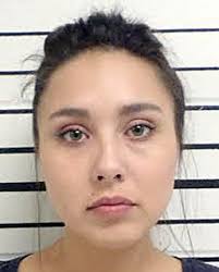 Woman charged with knifing man in the back