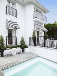 Black And White Striped Outdoor Awnings Black And White Greek Key Pool Tile Black And White Striped Awning And Chairs Greg Natale Sydney Based Architects An Outdoor Awnings House Windows Exterior