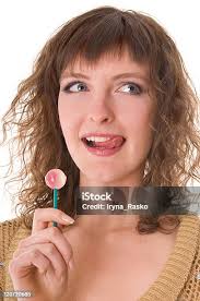 Woman Licking Sweet Sugar Candy Stock Photo