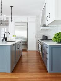 Steel is shiny and these sleek cabinets will give a sophisticated look to your kitchen. White And Blue Kitchen With Gray Backsplash Tiles Transitional Kitchen