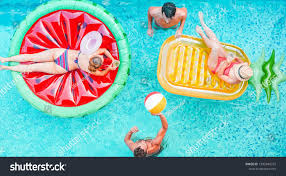 Happy Friends Playing With Air Lilo Ball Inside Swimming Pool Young People Having Fun On Summer Holidays Vacat In 2020 Happy Friends People Having Fun Vacation Trips
