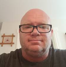 What racks can be used above the covered rear storage to hold items?