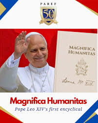 A smiling figure in white robes waves while holding a document titled 'Magnifica Humanitas' against a red background.