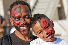 Using black face paint, paint the tip of the nose and above the lip. Tribal Red Face Paint Father And Son