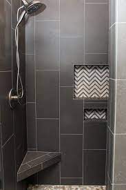 For that, there are many solutions. Dark Gray Tiled Shower With White And Gray Chevron Tile Accent Niche Shower Tile Designs Black Shower Tile Shower Tile