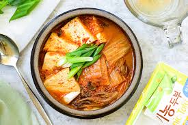 The most elaborate versions have a combination of seafood such as calamari, scallops, clams and shrimp along with zucchini, green onions and onions. This One Pot Kimchi Jjigae Is Korean Comfort Food At Its Best Eatingwell