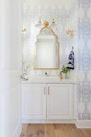 Powder Room Wallpaper With Gold Mirror And Gold Wall Sconces White Bathroom Cabinets Powder Room Design Bathroom Inspiration