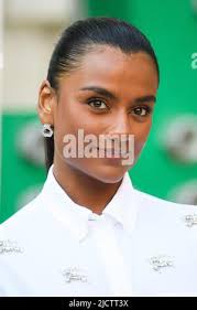 London, UK. 8 June 2022. Ashley Joiner, Queercircle founder, poses with  “Let Me Hold You”, a curved mural, by painter Michaela Yearwood-Dan,
