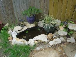 I like the use of stone, cement squares and brick edging.a lot! Small Koi Pond In Our Backyard Small Backyard Ponds Outdoor Ponds Pond Landscaping