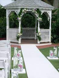Celebration Country Club S Beautiful Gazebo Decorated With Lush Foliage Garland And Floral Accents The Gazebo Wedding Gazebo Decorations Ceremony Decorations