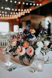 Diy ideas for wedding centerpieces, including flowers in baskets, vases and small bottles. 5 Clever Ways To Repurpose Your Wedding Decor From Ceremony To Reception Junebug Weddings