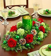 Red Flowers And Greens For Christmas Complete With A Christmas Candle In Th Christmas Flower Arrangements Christmas Flowers Christmas Arrangements Centerpieces