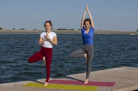 This article explores yoga poses for two people, benefits of partner yoga, and both easy and hard poses you can try! Two Young Women Doing Yoga At Nature Fitness Sport Yoga And Healthy Lifestyle Concept Group Of People Making Yoga Pose On Lake Pier At Sunset Stock Images Page Everypixel