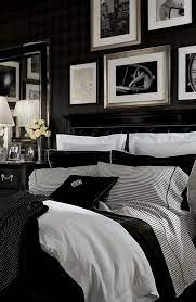 A very refined bedroom with black walls, paneling, black and pink floral bedding, a blush chair and a pendant lamp. Black Design Inspiration For A Master Bedroom Decor Hauptschlafzimmer Schlafzimmer Design Wohnen