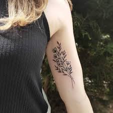 An armband tattoo usually goes on the upper arm, or more accurately the upper bicep. Subtle Flowers Tattoo On The Bicep Tattoogrid Net