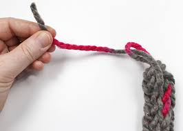 Start knitting like you can see in the pictures and continue the process until you have 5 inches left, carefully take the loops down from your fingers and secure them by making a knot. How To Make A Finger Knit Bracelet Factory Direct Craft Blog