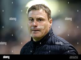 Mansfield Town manager David Flitcroft directs his team from the sideline  Stock Photo