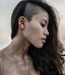 A Head Shoulder Picture Of A Young Asian Woman With A Side Shave Her Body Is Covered With Sand Half Shaved Hair Shaved Long Hair Shaved Sides