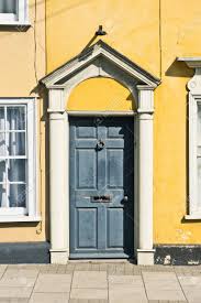 Black front doors are more popular and stylish than you think. A Grey Front Door In A Yellow House Stock Photo Picture And Royalty Free Image Image 45263248